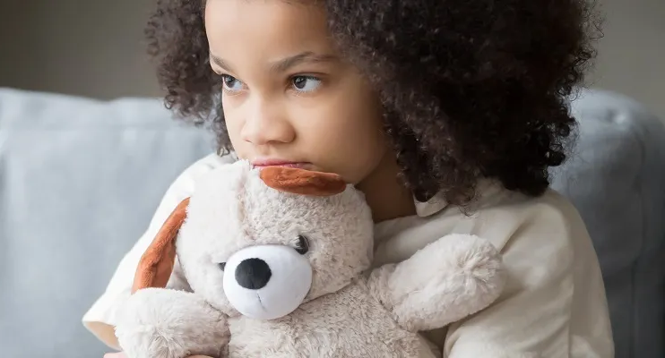 Girl holding a teddy bear 