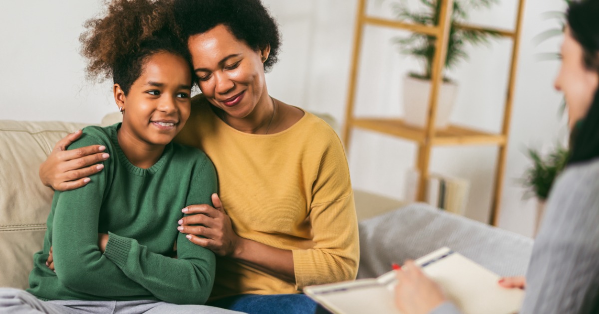 Mother and teenager daughter talk with therapist