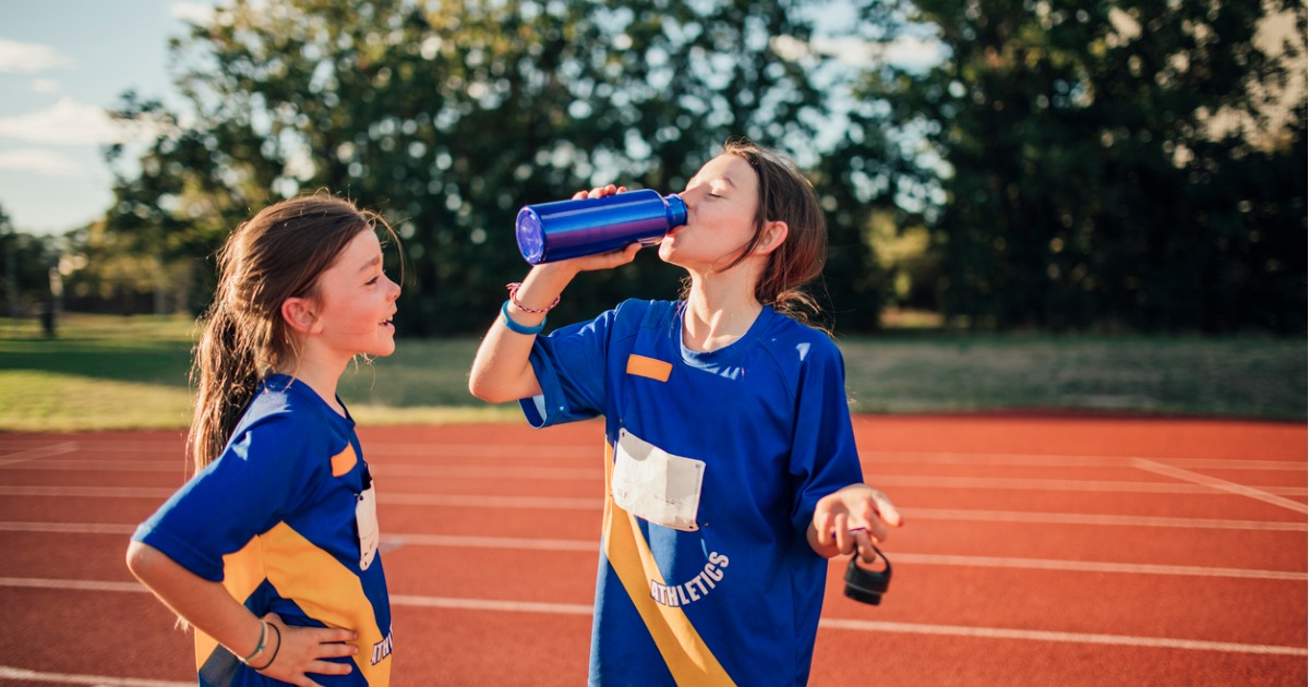 Two young girls take a water break