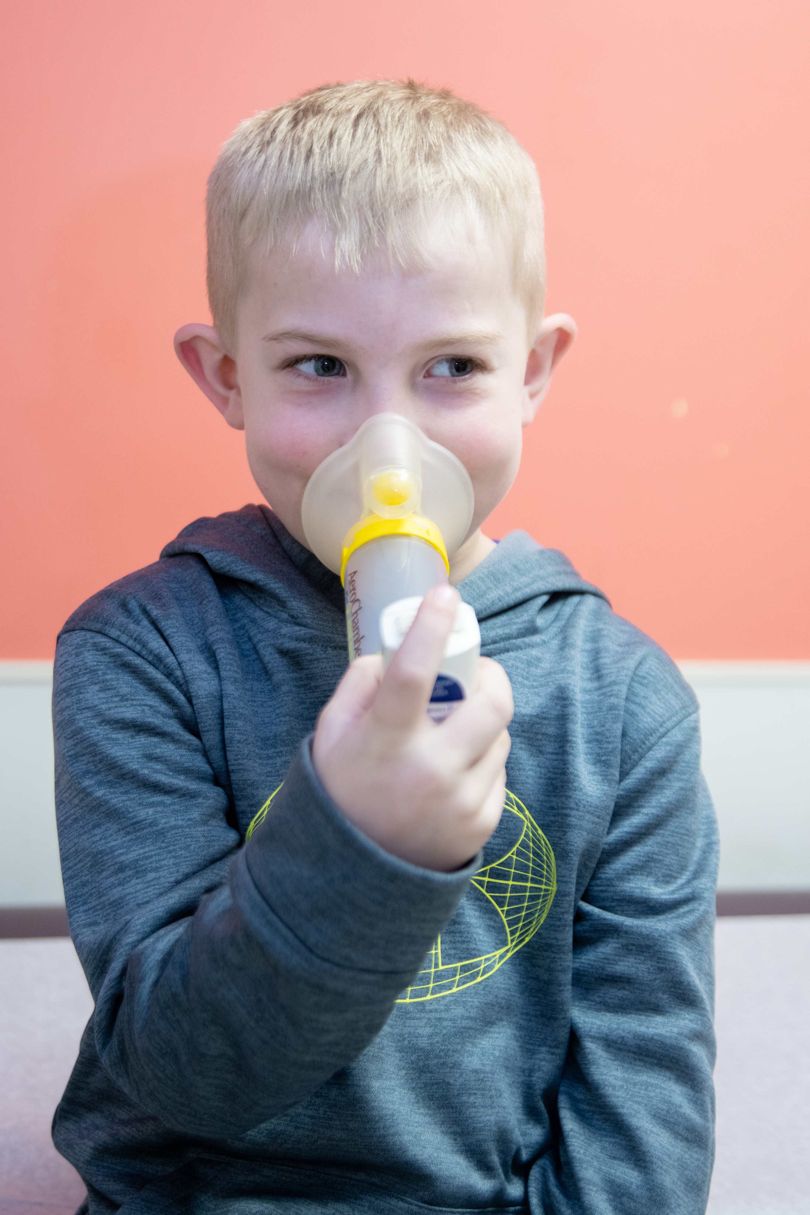 Child taking inhaler. 