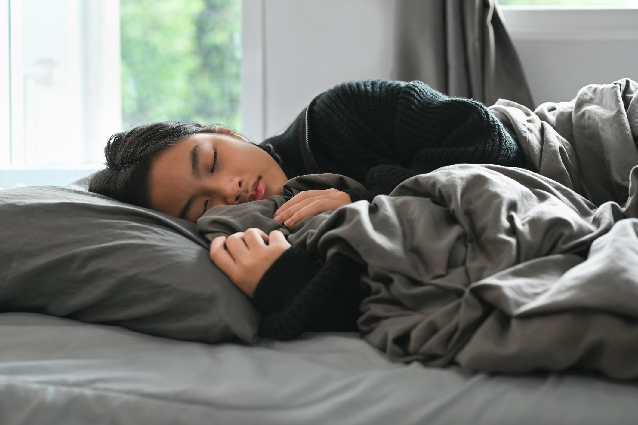 Teenage female sleeping. Athletic training and sleep together are important.