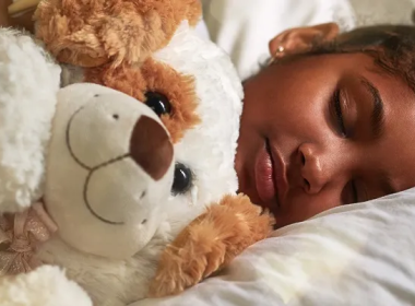 Girl sleeping with a teddy bear