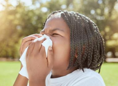 Child blowing nose outside, summer safety tips for those nose