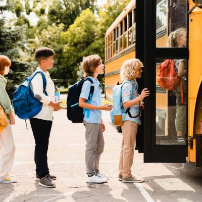 Kids getting on a school bus
